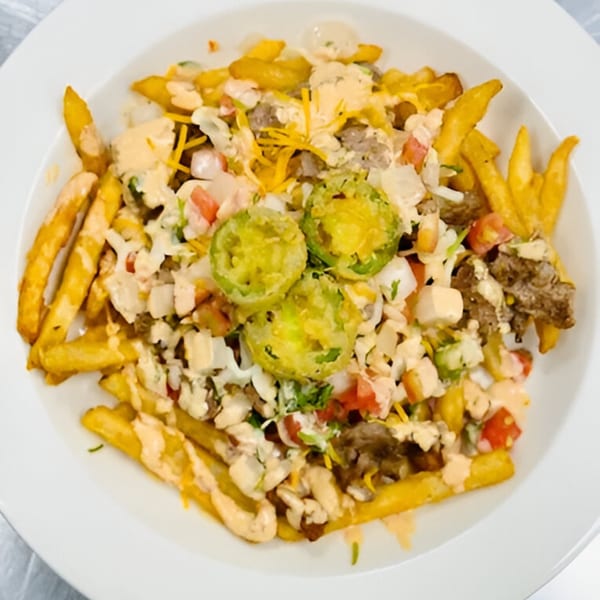 Sims Cafe's loaded fries topped with meat, cheese, vegetables, and creamy sauce.