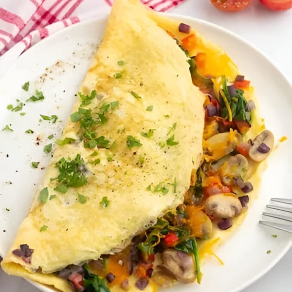Sims Cafe's omelet filled with mushrooms, spinach, peppers, and cheese, garnished with parsley.